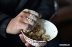 Feb. 1, 2019 -- A herdsman makes zanba, a staple for Tibetans, at a herdsman resettlement site in Bange County, southwest China`s Tibet Autonomous Region, Jan. 17, 2019. In the past, herdsmen in Tibet endured a ridiculously long, cold winter from October to the end of June, before moving to the summer meadow. They had no fixed residence and migrated when the seasons changed, taking their tents, kitchen utensils and other necessities on horseback. Nowadays, most herdsmen benefit from local resettlement program. They said goodbye to their winter hovels and moved into brick-and-mortar Tibetan-style homes. (Xinhua/Chogo)
