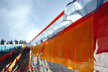 People replace prayer flags to celebrate New Year under Tibetan calendar