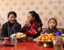 Feb. 11, 2019 -- Nyidron (C) eats Kasai, a traditional Tibetan pastry for the New Year, at home in Chengguan District of Lhasa, capital of southwest China`s Tibet Autonomous Region, Jan. 27, 2019. (Xinhua/Wu Tao)