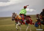 Urgyen competes in a horse race in Ngari Prefecture, southwest China`s Tibet Autonomous Region, Aug. 6, 2018. Since 1990, horses have been drifting away from plateau life, as most villages are connected to modern road networks these days. In some places, however, horses have regained their status as a mode of transport. Gyumey Dorje lives at the foot of Mt. Gang Rinpoche, a sacred mountain for Tibetans and a hot tourist attraction. There, villagers offer tourists services such as horseback riding or transferring goods up and down the mountain. `The horse is no common livestock,` said Ngawang Tenzin from the local culture authority. `The changing status of horses reflects the development of Tibet.` (Xinhua/Zhou Jianwei)