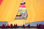 Feb. 18, 2019 -- Lamas of the Labrang Monastery uncover the large yellow curtain on a huge thangka scroll painting bearing the image of the Buddha during the annual `sunning of the Buddha` ceremony of Labrang Monastery in Xiahe County, northwest China`s Gansu Province, on Feb. 17, 2019. The annual `sunning of the Buddha` is one of the most important ceremonies at Labrang, which is regarded as a top Tibetan Buddhism educational institution in China. The ceremony is held each year on the 13th day of the first lunar month. It also attracted crowds of tourists. Built in 1709, Labrang Monastery is one of the six great monasteries of the Gelug Sect of Tibetan Buddhism. (Xinhua/Chen Bin)