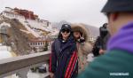 Feb. 18, 2019 -- Tourists pose for photos in front of the Potala Palace in Lhasa, southwest China`s Tibet Autonomous Region, Feb. 9, 2019. The Tibetan New Year, known as Losar, is the most important festival in the Tibetan calendar. This year`s Losar fell on Feb. 5 and coincided with the Spring Festival. Losar is a time for family reunions. It is marked by religious rituals, long prayers, horse racing, family gatherings and feasts. As the festival draws near, people go shopping, do some cleaning and decorate their folk houses. Families feast on Tibetan food. Women make Kharbse, a popular dish made from flour and yak butter, and guthuk, a traditional snack similar to a dumpling. People plant their own highland barley, which is believed to indicate the harvest in the following year. On the altar in the living room there are placed, a pastry in the shape of a sheep head, a pot of highland barley, dates, air-dried beef, candies, nuts, butter, and brown sugar, presented to pray for prosperity and good weather for crops. In Tibetan `sheep head` is pronounced similarly to `the year`s beginning` thus making it an auspicious symbol. Guthuk are sometimes filled with `surprises` including charcoal, wool or chillies. Someone who receives a guthuk filled with wool is described as being `good-natured`, while coins or wheat mean good fortune. The food is washed down with highland barley liquor. Celebrations of the Tibetan New Year usually last for 15 days. Local people also participate in activities including Tibetan opera performance, folk dancing, archery and wrestling. (Xinhua/Jigme Dorje)