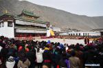 Feb. 19, 2019 -- People watch exorcism dance performed by masked lamas at a square of the Labrang Monastery in Xiahe County, northwest China`s Gansu Province, Feb. 18, 2019. The Labrang Monastery held the annual event of exorcism dance to pray for good luck in the new year. Built in 1709, Labrang Monastery is one of the six great monasteries of the Gelug Sect of Tibetan Buddhism. (Xinhua/Chen Bin)