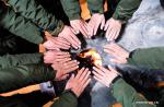 Feb. 28, 2019 -- Wildlife management and conservation station staff members warm their hands by the fire in Shuanghu County, southwest China`s Tibet Autonomous Region, Feb. 1, 2019. Shuanghu County, located 5,000 meters above sea level in southwest China`s Tibet Autonomous Region, suffers from strong winds 200 days a year. With a year-round temperature averaging minus five degrees Celsius, Shuanghu is home to the world`s third largest glacier, the Purog Kangri. Occasionally, the temperature here drops to minus 40 degrees Celsius. The county, about 120,000 square kilometers in area, lies in the middle of the Qiangtang National Nature Reserve. There are 135 conservation staff members working in Shuanghu`s 15 wildlife management and conservation stations to improve protection of wild animals. In 2018, the county government suspended construction of tourism-related support facilities around the Purog Kangri glacier to better protect the environment. Shuanghu now has about 20,000 wild yaks and 200,000 Tibetan antelopes, plus more than 20 rare species such as the snow leopard and brown bear. (Xinhua/Purbu Zhaxi)