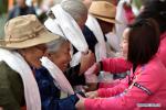 Mar. 25, 2019 -- Young people present hada, a white ceremonial silk scarf, to the elderly in an event to celebrate the 60th anniversary of democratic reforms in Tibet, at a community in Lhasa, capital of southwest China`s Tibet Autonomous Region, March 23, 2019. (Xinhua/Chogo)