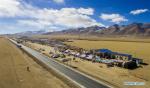 April 8, 2019 -- Aerial photo taken on Nov. 25, 2017 shows a livestock products fair by the side of Qinghai-Tibet highway in Nagqu of southwest China`s Tibet Autonomous Region. According to the white paper `Democratic Reform in Tibet -- Sixty Years On` issued in March of 2019, by the end of 2018, Tibet had 97,800 km of highway, 660 km of which were high-grade highways. All counties in Tibet had access to highways, and of the 697 townships and towns, 579 had direct access to highway transport and 696 could be reached by highways. Of the 5,467 villages in Tibet, 2,624 had direct access to highway transport and 5,457 could be reached by highway. In 2006, the Golmud-Lhasa section of the Qinghai-Tibet Railway was completed and opened to traffic, which was the first railway in Tibet. In 2014, the construction of Lhasa-Shigatse Railway was completed and tracklaying started on the Lhasa-Nyingchi Railway. (Xinhua/Liu Dongjun)