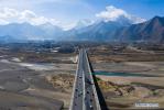 April 8, 2019 -- Aerial photo taken on April 3, 2019 shows a highway in Lhasa, southwest China`s Tibet Autonomous Region. According to the white paper `Democratic Reform in Tibet -- Sixty Years On` issued in March of 2019, by the end of 2018, Tibet had 97,800 km of highway, 660 km of which were high-grade highways. All counties in Tibet had access to highways, and of the 697 townships and towns, 579 had direct access to highway transport and 696 could be reached by highways. Of the 5,467 villages in Tibet, 2,624 had direct access to highway transport and 5,457 could be reached by highway. In 2006, the Golmud-Lhasa section of the Qinghai-Tibet Railway was completed and opened to traffic, which was the first railway in Tibet. In 2014, the construction of Lhasa-Shigatse Railway was completed and tracklaying started on the Lhasa-Nyingchi Railway. (Xinhua/Purbu Zhaxi)