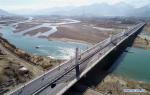 April 8, 2019 -- Aerial photo taken on April 3, 2019 shows the Najin Bridge in Lhasa, southwest China`s Tibet Autonomous Region. According to the white paper `Democratic Reform in Tibet -- Sixty Years On` issued in March of 2019, by the end of 2018, Tibet had 97,800 km of highway, 660 km of which were high-grade highways. All counties in Tibet had access to highways, and of the 697 townships and towns, 579 had direct access to highway transport and 696 could be reached by highways. Of the 5,467 villages in Tibet, 2,624 had direct access to highway transport and 5,457 could be reached by highway. In 2006, the Golmud-Lhasa section of the Qinghai-Tibet Railway was completed and opened to traffic, which was the first railway in Tibet. In 2014, the construction of Lhasa-Shigatse Railway was completed and tracklaying started on the Lhasa-Nyingchi Railway. (Xinhua/Jigme Dorje)