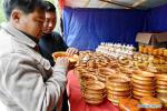 ​June 3, 2019 -- Customers choose wooden bowls during an international border trade, tourism and culture festival in Yadong County, southwest China`s Tibet Autonomous Region, June 2, 2019. An international border trade, tourism and culture festival kicked off in Yadong County on Sunday. A series of events including exhibitions, fitness programs and investment promotions will be held in the week-long festival. (Xinhua/Zhang Rufeng)