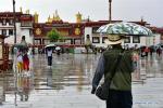 July 9, 2019 -- People walk in rain near the Jokhang Temple in Lhasa, southwest China`s Tibet Autonomous Region, July 3, 2019. (Xinhua/Zhang Rufeng)
