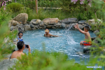 July 22, 2019 -- Tourists take a bath in hot spring water in Dagdong Village in Lhasa, southwest China`s Tibet Autonomous Region, July 20, 2019. Dagdong Village, once a poverty-stricken village, has a history of over 1,000 years. In recent years, Dagdong promoted culture and tourism industry as a targeted measure in poverty alleviation campaigns. (Xinhua/Zhang Rufeng)