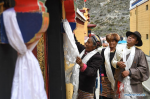 Sept.23, 2019 -- Dainzin Quzhen (1st L) presents a hada scarf to her new house in Lhozhag Town of Lhozhag County, Shannan City, southwest China`s Tibet Autonomous Region, Sept. 21, 2019. A total of 88 villagers from 28 households moved to their new two-story dwellings to improve housing conditions. (Xinhua/Jigme Dorje)
