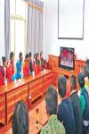 Oct.11, 2019 -- Photo shows people of Bomuqing Community holding Chinese national flags and watching the 70th anniversary parade on TV. [China Tibet News/Chen Lin  Tashi Dondrup  Zhang Bin]