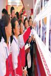 Oct.11, 2019 -- Photo shows students visiting the achievement exhibition on Xigaze economic and social development marking the the 70th anniversary of the founding of the People`s Republic of China and the 60th anniversary of democratic reform in Tibet. [China Tibet News/Chen Lin  Tashi Dondrup  Zhang Bin]