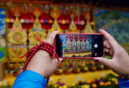 Oct.22, 2019 -- A visitor takes a picture during an event celebrating the 600th anniversary of the founding of Sera Monastery in Lhasa, capital of southwest China`s Tibet Autonomous Region, Oct. 20, 2019.(Xinhua/Purbu Zhaxi)