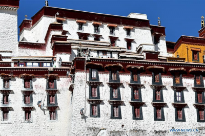 Workers paint wall of Potala Palace in Lhasa, Tibet