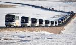 Dec.25,2019 -- Photo taken on Dec. 23, 2019 shows a fleet of buses carrying herders migrating from Shuanghu County, Nagchu City, southwest China`s Tibet Autonomous Region. A total of 2,900 residents from three villages of Shuanghu County, have recently left their hometown with an average altitude of 5,000 meters above sea level and travelled nearly 1,000 kilometers to resettle in Konggar County, which, at a relatively low altitude, is located to the south bank of the Yarlung Zangbo River in southern Tibet. (Xinhua/Chogo)