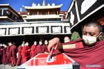 Feb.7,2020 -- Monks line up to donate money to novel coronavirus-infected areas at the Jokhang Temple in Lhasa, capital of southwest China`s Tibet Autonomous Region, Feb. 4, 2020. Tibetan Buddhist temples held prayer services to support novel coronavirus-infected areas in China. The monks here were also organized to donate money to help fight against the epidemic. (Xinhua/Chogo)