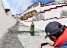 March 2,2020 -- A tour guide speaks during a live streaming tour in the Potala Palace, a UNESCO world heritage, in Lhasa, southwest China`s Tibet Autonomous Region, March 1, 2020. The Potala Palace, a landmark in southwest China`s Tibet Autonomous Region, held a live streaming tour session Sunday, the first time in its over 1,300-year history. (Xinhua/Chun La)