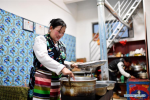 April 8,2020 -- Oucuo and her son Sonam Pubu work at their restaurant at the Rongma relocation settlement in Gurum Township of Lhasa, capital of southwest China`s Tibet Autonomous Region, April 1, 2020. In 2018, more than 1,000 shepherds moved from Qiangtang grassland with an average altitude of about 5,000 meters in Rongma Township of Nagqu City to the Rongma relocation settlement, 30 kilometers west of Lhasa, thanks to the local policy on poverty alleviation. This measure also makes room for the living of wild animals at the Qiangtang National Nature Reserve. With the help of local government, the relocated people have developed the cultivation industry of yaks and sheep and other special pasture-style projects, thus increasing their incomes. (Xinhua/Zhan Yan)