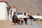 April 8,2020 -- Meiqiong and his children have fun at the Rongma relocation settlement in Gurum Township of Lhasa, capital of southwest China`s Tibet Autonomous Region, April 1, 2020. In 2018, more than 1,000 shepherds moved from Qiangtang grassland with an average altitude of about 5,000 meters in Rongma Township of Nagqu City to the Rongma relocation settlement, 30 kilometers west of Lhasa, thanks to the local policy on poverty alleviation. This measure also makes room for the living of wild animals at the Qiangtang National Nature Reserve. With the help of local government, the relocated people have developed the cultivation industry of yaks and sheep and other special pasture-style projects, thus increasing their incomes. (Xinhua/Zhan Yan)