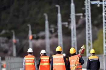 Technicians work at construction site of power supply system of Lhasa-Nyingchi railway