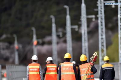 Technicians work at construction site of power supply system of Lhasa-Nyingchi railway