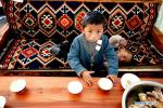 April 21,2020 -- Zhaxi Nyima (front) and Puba Doje, Gedor`s sons, are seen in their family`s teahouse at a relocation site in Gangdoi Town of Gonggar County, southwest China`s Tibet Autonomous Region, April 15, 2020. Gedor, 34, used to live in a remote pastoral area in Amdo County in northern Tibet with his family. Restricted by the living conditions, they earned a living by pasture and the low income of their small grocery store. In late 2019, with the support of local authorities, 4,058 residents in Amdo and Co Nyi, two counties at a high altitude of over 4,500 meters, were relocated. Gedor and his family moved to a relocation site in Gangdoi Town of Gonggar County. The site has easy access to roads and various facilities including market, hospital and school. The convenience of new life has encouraged Gedor and his wife Rolpai to open a Tibetan butter teahouse for neighboring residents to spend leisure time. Now, Gedor and his family live a better life as their teahouse has been a popular spot with satisfactory income, and with the allowance from local authorities. (Xinhua/Zhan Yan) 