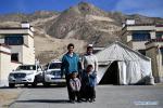 April 21,2020 -- Gedor (L, back) poses for a group photo with his wife Rolpai (R, back), his sons Zhaxi Nyima (R, front) and Puba Doje in front of their teahouse at a relocation site in Gangdoi Town of Gonggar County, southwest China`s Tibet Autonomous Region, April 15, 2020. Gedor, 34, used to live in a remote pastoral area in Amdo County in northern Tibet with his family. Restricted by the living conditions, they earned a living by pasture and the low income of their small grocery store. In late 2019, with the support of local authorities, 4,058 residents in Amdo and Co Nyi, two counties at a high altitude of over 4,500 meters, were relocated. Gedor and his family moved to a relocation site in Gangdoi Town of Gonggar County. The site has easy access to roads and various facilities including market, hospital and school. The convenience of new life has encouraged Gedor and his wife Rolpai to open a Tibetan butter teahouse for neighboring residents to spend leisure time. Now, Gedor and his family live a better life as their teahouse has been a popular spot with satisfactory income, and with the allowance from local authorities. (Xinhua/Zhan Yan)