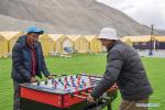 May 8,2020 -- People play games at the Mount Qomolangma base camp in southwest China`s Tibet Autonomous Region, May 1, 2020. China has initiated a new round of measurement on the height of Mount Qomolangma, the world`s highest peak. The measurement team arrived at the base camp one month ago, making preparation for the measurement planned in May. As an important starting point and rear base for mountaineering, the Mount Qomolangma base camp is equipped with basic living facilities and medical supplies. (Xinhua/Sun Fei)