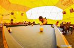 May 8,2020 -- A man plays billiards at the Mount Qomolangma base camp in southwest China`s Tibet Autonomous Region, May 1, 2020. China has initiated a new round of measurement on the height of Mount Qomolangma, the world`s highest peak. The measurement team arrived at the base camp one month ago, making preparation for the measurement planned in May. As an important starting point and rear base for mountaineering, the Mount Qomolangma base camp is equipped with basic living facilities and medical supplies. (Xinhua/Jigme Dorje)
