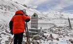 May 28,2020 -- Chinese surveyor Zheng Lin conducts surveying at Mount Qomolangma base camp in southwest China`s Tibet Autonomous Region on May 27, 2020. A Chinese survey team reached the summit of Mount Qomolangma Wednesday, and remeasured the height of the world`s highest peak. After summiting at 11 a.m., the eight-member team erected a survey marker and installed a GNSS antenna on the snow-covered peak, which measures less than 20 square meters, while other surveyors conducted observations from six points beneath the peak. (Xinhua/Jigme Dorje)