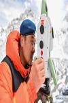 May 28,2020 -- Chinese surveyor Zheng Lin conducts surveying at Mount Qomolangma base camp in southwest China`s Tibet Autonomous Region on May 27, 2020. A Chinese survey team reached the summit of Mount Qomolangma Wednesday, and remeasured the height of the world`s highest peak. After summiting at 11 a.m., the eight-member team erected a survey marker and installed a GNSS antenna on the snow-covered peak, which measures less than 20 square meters, while other surveyors conducted observations from six points beneath the peak. (Xinhua/Sun Fei)