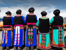 June 13,2020 -- A group of women dressed in traditional Qiang ethnic minority dress stand on the roof of a residential house as clouds come into their view, in Jiashan village, Lixian county, Aba Tibetan and Qiang autonomous prefecture, Southwest China`s Sichuan province. [Photo provided to chinadaily.com.cn]