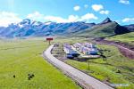 June 18,2020 -- Aerial photo taken on June 14, 2020 shows a relocated area next to No. 317 national highway in Qamdo, southwest China`s Tibet Autonomous Region. Located in eastern Tibet region, Qadom City has witnessed a total of 194,600 residents, 38,400 households, 1,127 villages and 11 counties get rid of poverty thanks to the poverty alleviation efforts. (Xinhua/Tian Jinwen)