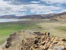 June 23,2020 -- Tourists from Lhasa join a group tour at the Yamzbog Yumco Lake scenic area in Shannan, southwest China`s Tibet Autonomous Region, June 20, 2020. Consumption coupons have been handed out to residents of Tibet Autonomous Region to boost local tourism amid the COVID-19 pandemic. (Xinhua/Cao Pengyuan)