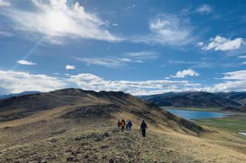 Tourists from Lhasa join group tour at Yamzbog Yumco Lake scenic area in Shannan