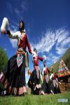 July 21,2020 -- Apprentices of Nyima perform Jiuhe Zhuo dance in Jiuhe Village of Qonggyai County in Shannan, southwest China`s Tibet Autonomous Region, July 1, 2020. Jiuhe Zhuo dance, originated in Qonggyai County of Shannan, has a history of more than 1,300 years. It has been a favorite dancing form for local people in Shannan to pray for good luck since ancient times and was dubbed waist drum dance in Tibet. Nyima, an inheritor of Jiuhe Zhuo dance, which is a national intangible cultural heritage, began to learn the dance from his father at the age of nine and has been dedicated to Zhuo dance performance for over 60 years. His performance once won a national award for folk arts. After decades of study of the dance, Nyima has formed his unique style. During the performance, he plays the role of leading dancer and controls the movements and rhythm of the dance. Nyima has trained dozens of apprentices and formed a Zhuo dance performing team in Jiuhe Village. Now, young dancers of the team often perform in different places. The Zhuo dance has become an important approach to reducing poverty for local villagers. (Xinhua/Zhan Yan)