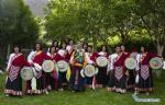 July 21,2020 -- Nyima and his apprentices pose for a group photo in Jiuhe Village of Qonggyai County in Shannan, southwest China`s Tibet Autonomous Region, July 1, 2020. Jiuhe Zhuo dance, originated in Qonggyai County of Shannan, has a history of more than 1,300 years. It has been a favorite dancing form for local people in Shannan to pray for good luck since ancient times and was dubbed waist drum dance in Tibet. Nyima, an inheritor of Jiuhe Zhuo dance, which is a national intangible cultural heritage, began to learn the dance from his father at the age of nine and has been dedicated to Zhuo dance performance for over 60 years. His performance once won a national award for folk arts. After decades of study of the dance, Nyima has formed his unique style. During the performance, he plays the role of leading dancer and controls the movements and rhythm of the dance. Nyima has trained dozens of apprentices and formed a Zhuo dance performing team in Jiuhe Village. Now, young dancers of the team often perform in different places. The Zhuo dance has become an important approach to reducing poverty for local villagers. (Xinhua/Purbu Zhaxi)