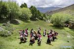 July 21,2020 -- Nyima and his apprentices perform Jiuhe Zhuo dance in Jiuhe Village of Qonggyai County in Shannan, southwest China`s Tibet Autonomous Region, July 1, 2020. Jiuhe Zhuo dance, originated in Qonggyai County of Shannan, has a history of more than 1,300 years. It has been a favorite dancing form for local people in Shannan to pray for good luck since ancient times and was dubbed waist drum dance in Tibet. Nyima, an inheritor of Jiuhe Zhuo dance, which is a national intangible cultural heritage, began to learn the dance from his father at the age of nine and has been dedicated to Zhuo dance performance for over 60 years. His performance once won a national award for folk arts. After decades of study of the dance, Nyima has formed his unique style. During the performance, he plays the role of leading dancer and controls the movements and rhythm of the dance. Nyima has trained dozens of apprentices and formed a Zhuo dance performing team in Jiuhe Village. Now, young dancers of the team often perform in different places. The Zhuo dance has become an important approach to reducing poverty for local villagers. (Xinhua/Purbu Zhaxi)
