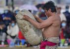 Aug.13,2020 -- A herdsman holds a big stone during a stone-lifting competition in a horse racing fair held in Naqu City, southwest China`s Tibet Autonomous Region, Aug. 10, 2020. (Xinhua/Zhang Rufeng)