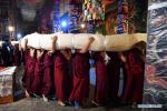 Aug.20,2020 -- Buddhist monks carry a huge Thangka painting at the Drepung Monastery in Lhasa, southwest China`s Tibet Autonomous Region, Aug. 19, 2020. Celebrations for the traditional Shoton Festival, or Yogurt Festival, began in Lhasa on Wednesday. (Xinhua/Zhan Yan)