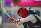 Nov.23,2020 -- A contestant from Mangkam County of Qamdo in Tibet Autonomous Region performs before the traditional `Gongbo archery` competition in Nyingchi, southwest China`s Tibet Autonomous Region, Nov. 19, 2020. A traditional archery competition was held in Nyingchi on Thursday to celebrate the Gongbo New Year. This year, more than 260 archery enthusiasts from Nyingchi participated in the competition. `Gongbo archery`, with a history of over 1,500 year, is a traditional folk sports competition which is unique to Nyingchi. It has been listed as an intangible cultural heritage of Tibet. There are small holes on the wooden cone head of the arrow. When the arrow flies to target, the air passes through the hole and makes a sharp whistling sound. A cloth curtain with a leather target is hung on the other side of the arena. After hitting the target, the arrow falls off together with the inner ring of leather target. (Xinhua/Purbu Zhaxi)