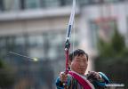 Nov.23,2020 -- A contestant from Yadong County of Xigaze in Tibet Autonomous Region performs before the traditional `Gongbo archery` competition in Nyingchi, southwest China`s Tibet Autonomous Region, Nov. 19, 2020. A traditional archery competition was held in Nyingchi on Thursday to celebrate the Gongbo New Year. This year, more than 260 archery enthusiasts from Nyingchi participated in the competition. `Gongbo archery`, with a history of over 1,500 year, is a traditional folk sports competition which is unique to Nyingchi. It has been listed as an intangible cultural heritage of Tibet. There are small holes on the wooden cone head of the arrow. When the arrow flies to target, the air passes through the hole and makes a sharp whistling sound. A cloth curtain with a leather target is hung on the other side of the arena. After hitting the target, the arrow falls off together with the inner ring of leather target. (Xinhua/Purbu Zhaxi)