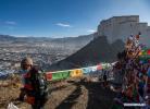 Jan.18,2021 -- Tibetan people hang prayer flags on top of a mountain in Xigaze, southwest China`s Tibet Autonomous Region, Jan. 15, 2021. Friday marks the third day of the farmers` New Year celebrated in Xigaze according to the Tibetan lunar calendar. In tradition, people here would go early this morning to hang new prayer flags on top of mountains and their home roofs, praying for peace and prosperity of their country. (Xinhua/Sun Fei)