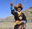 March 17,2021 -- A woman sows highland barley seeds as she takes part in a ceremony marking the start of spring ploughing in Shannan, southwest China`s Tibet Autonomous Region, March 16, 2021. (Xinhua/Jigme Dorje)