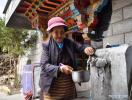 March 18,2021 -- Dawa fetches tap water in her own yard in Kesum Community of Shannan City, southwest China`s Tibet Autonomous Region, March 15, 2021. Dawa, 84, a former serf of Kesum manor in old Tibet, has experienced great changes in her life. `When I was a serf, I had to work day and night with little food and no human rights at all,` Dawa recalled. Now she lives in a well-furnished traditional Tibetan style courtyard in Kesum community, a forerunner in the region`s democratic reform, and enjoys her old-age life with her family. `I wish I could live longer to see more development in Tibet,` Dawa added. The peaceful liberation of Tibet in 1951, the democratic reform in 1959 and the establishment of Tibet Autonomous Region in 1965, have paved way for the remarkable development in the region and improvements in the lives of people of all ethnic groups there. The plateau region in southwest China will celebrate its 70th anniversary of the peaceful liberation this year. With historic leaps in development, people in Tibet have enjoyed a much better life. Those who shook off poverty no longer worry about their needs of food, clothing, housing, education and medical care. The region offers 15 years of free education. Besides, traditional culture has been effectively protected and inherited, and medical and health care has greatly improved. (Xinhua/Jigme Dorje)