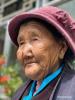 March 18,2021 -- Dawa looks on in her own yard in Kesum Community of Shannan City, southwest China`s Tibet Autonomous Region, March 15, 2021. Dawa, 84, a former serf of Kesum manor in old Tibet, has experienced great changes in her life. `When I was a serf, I had to work day and night with little food and no human rights at all,` Dawa recalled. Now she lives in a well-furnished traditional Tibetan style courtyard in Kesum community, a forerunner in the region`s democratic reform, and enjoys her old-age life with her family. `I wish I could live longer to see more development in Tibet,` Dawa added. The peaceful liberation of Tibet in 1951, the democratic reform in 1959 and the establishment of Tibet Autonomous Region in 1965, have paved way for the remarkable development in the region and improvements in the lives of people of all ethnic groups there. The plateau region in southwest China will celebrate its 70th anniversary of the peaceful liberation this year. With historic leaps in development, people in Tibet have enjoyed a much better life. Those who shook off poverty no longer worry about their needs of food, clothing, housing, education and medical care. The region offers 15 years of free education. Besides, traditional culture has been effectively protected and inherited, and medical and health care has greatly improved. (Xinhua/Purbu Zhaxi)