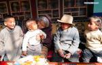 March 19,2021 -- Drungtok (C) enjoys time with her grandchildren at home in Xigaze, southwest China`s Tibet Autonomous Region, Jan. 15, 2021. Drungtok, a former serf of Bailug manor in old Tibet, has seen her life totally changed from before. In the old days, Drungtok and her ancestors worked as serfs at the Bailug manor, making barley wine for the manor owner to offset the duty. She offered their labor all year long but never drunk the wine herself. Nowadays, she lives in a Tibetan yard with her grandchildren, drinking barley wine and enjoying time with families. (Xinhua/Sun Fei)