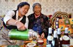April 13,2021 -- Penpa Tsamjo (R) receives a cup of tea from her neighbor in Xigaze, southwest China`s Tibet Autonomous Region, March 19, 2021. The 92-year-old Penpa Tsamjo is a resident of Bomuqing community in Xigaze. In old Tibet, Penpa Tsamjo`s family had been serfs for generations. When she was a child, Penpa Tsamjo tended forest for serf owners and did not have enough food to eat. Nowadays, Penpa Tsamjo has a family of four generations and enjoys a happy life at her old age. (Xinhua/Zhang Rufeng)